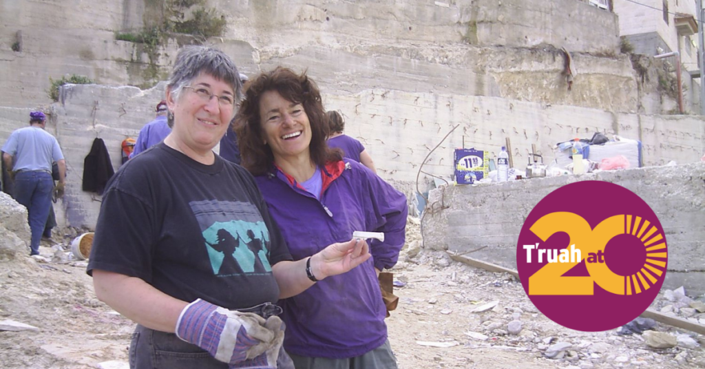 Rabbis Ellen Lippmann and Tirzah Firestone smile near a worksite. T'ruah at 20 logo.