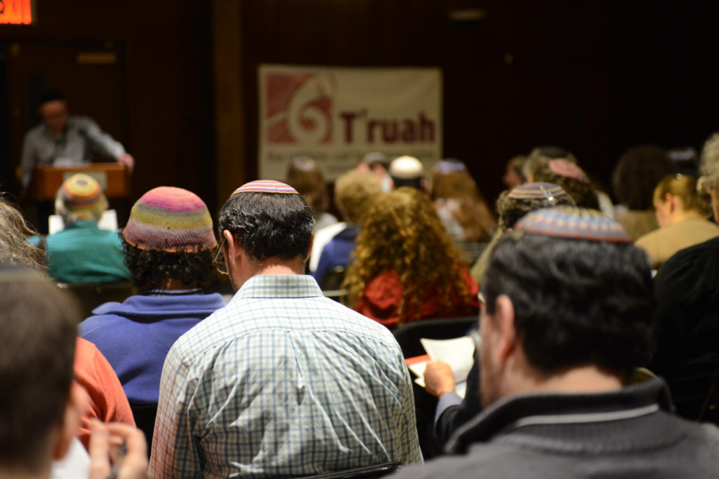 The backs of an audience watching a T'ruah presentation.