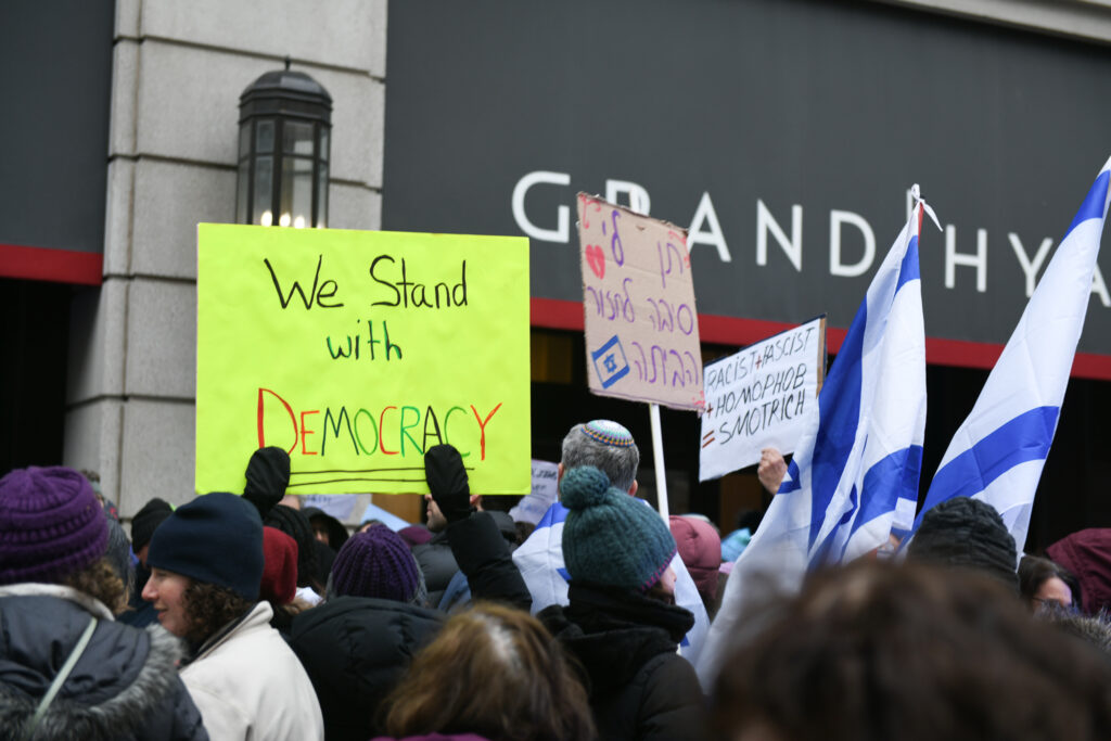 "We stand with democracy" sign at protest