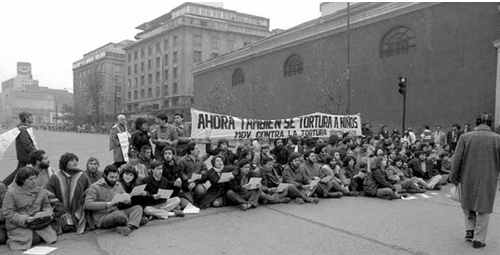 Members of the Sebastian Acevedo Movement Against Torture block traffic on Santiago’s main road.